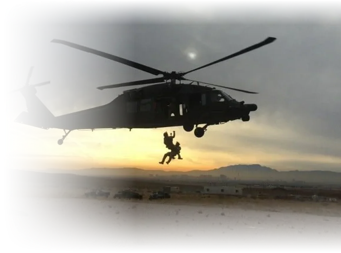 A helicopter hoisting two service members at dusk